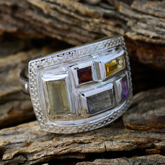 Ines multicolor gemstone cocktail ring with rectangular stones set in silver on rustic wood background