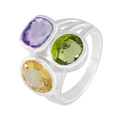 Camilla multicolor gemstone cocktail ring with purple, green, and yellow stones set in silver band