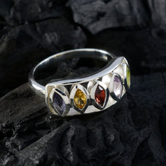 Aurora multicolor gemstone ring with five marquise cut stones set in silver band on dark textured background