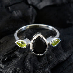 Yan multicolor gemstone trilogy ring with black center stone and green side gemstones on silver band