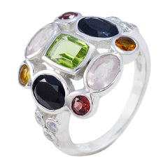 Laura multicolor navratna cocktail ring with green, black, pink, red, and orange gemstones set in silver band