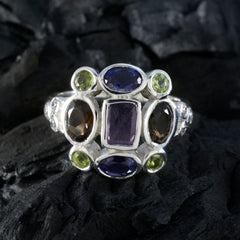 Meera navratna cocktail ring featuring multicolored gemstones set in a silver band