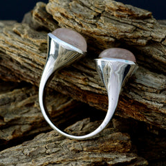 Araya pink toi et moi ring sterling silver open band with two rose quartz cabochons on wood backdrop