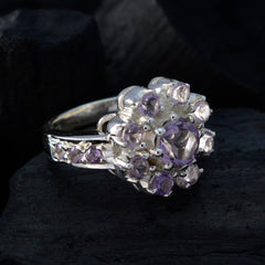 Bianca purple gemstone ring in sterling silver with floral cluster design, central round purple stone and side accents