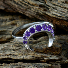 Lakshmi purple gemstone statement ring with crescent design and silver band on rustic wood