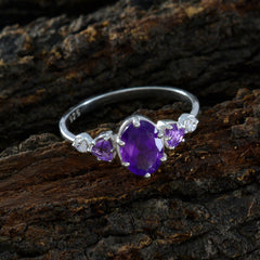 Julia sterling silver ring with central oval amethyst and two side stones purple gemstone trilogy ring