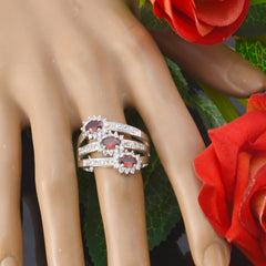 Chloe purple trilogy ring with three purple gemstones and diamond halo on silver band shown on hand with roses