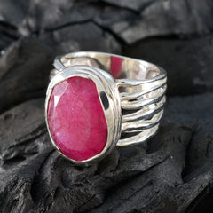 Elena red gemstone solitaire ring with silver band on textured dark background