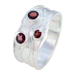 Penelope silver ring featuring a red gemstone trilogy ring design with three red stones