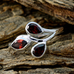 Putri red gemstone trilogy ring with three deep red teardrop stones set in silver band