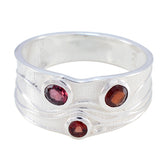 Penelope silver band red gemstone trilogy ring with three red oval gemstones set in unique design
