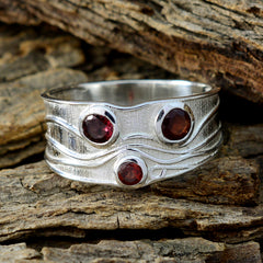 Penelope silver red gemstone trilogy ring with three round red stones on textured band