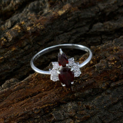 Isabelle red toi et moi ring with two pear shaped red gemstones and small diamond accents on silver band
