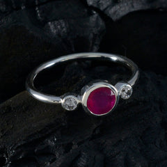 Kristine red trilogy gemstone ring with a central red stone and two smaller clear stones on silver band