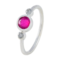 Kristine silver ring featuring a red trilogy gemstone ring design with one red center stone and two clear side stones