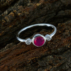 Kristine red trilogy gemstone ring with a central red stone flanked by two clear stones on silver band