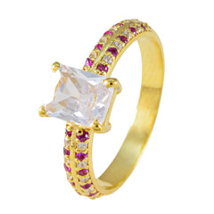 Camila gold ring with clear center stone and side romantic red gemstone ring accents