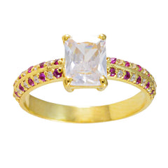 Camila romantic red gemstone ring with a large clear center stone and red and white accent stones on gold band
