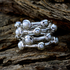 Ivy white gemstone stacked rings with silver band design placed on rustic wood background