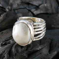 Ella white solitaire statement ring with large pearl set in multi-band silver on dark textured background