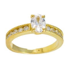 Gold engagement ring with oval white center stone and pave side crystals white stone glamorous ring