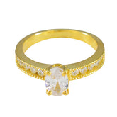 Seo yeon gold ring with oval white center stone and pave side stones white stone glamorous ring