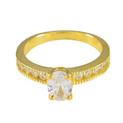 Seo yeon gold ring with oval white center stone and pave side stones white stone glamorous ring