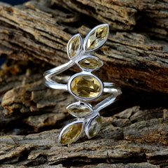 Antonia silver yellow gemstone leaf ring with marquise and oval faceted stones on rustic wood background