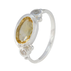 Hana yellow gemstone trilogy ring with oval yellow stone bezel set in sterling silver and two round clear accent stones