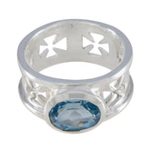 Isabella Irish blue solitaire ring with a faceted oval blue gemstone set in silver band with Celtic cross cutouts