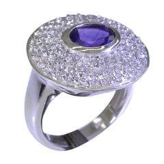Lakshmi purple halo ring featuring a central purple gemstone surrounded by sparkling clear stones