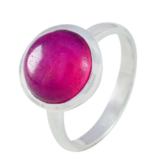 Lakshmi red solitaire ring with a polished silver band and vibrant round red stone