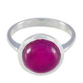 Lakshmi red solitaire ring with a polished silver band and round deep red stone centerpiece