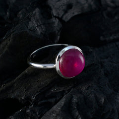 Lakshmi red solitaire ring with a round deep red gemstone set in a silver band