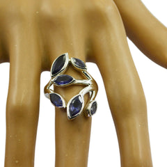 Natalia leaf design blue gemstone ring with silver band on a display hand