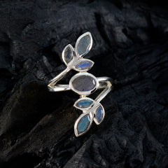 Anna leaf design gemstone ring with silver band and blue labradorite stones on dark textured background