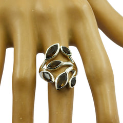 Genesis leafy brown gemstone ring with marquise-shaped stones set in silver on a display hand