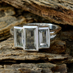 Natcha light green gemstone trilogy ring with three rectangular stones set in silver band on rustic wood