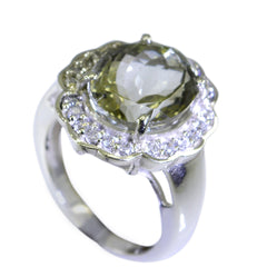 Natcha light green halo ring with round center stone and sparkling white accent stones