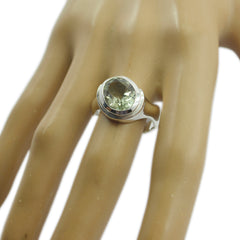Camila light green solitaire ring with round gemstone set in silver band on mannequin hand