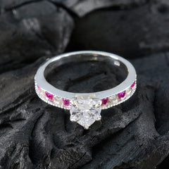 Yuki luxurious red gemstone ring with central clear stone and small red gemstones on silver band