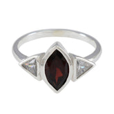 Emi ring featuring a luxurious red gemstone ring with two clear triangular side stones in silver setting