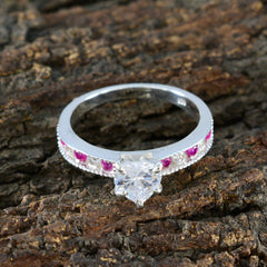 Yuki luxurious red gemstone ring with heart-shaped clear center stone and small red gemstones on band