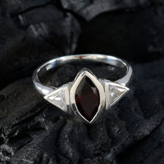 Emi luxurious red gemstone ring with marquise center stone and triangular clear side stones on silver band