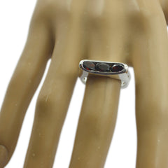 Elena silver band luxurious red gemstone ring with three oval red stones in horizontal bar setting on model hand