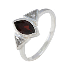 Emi luxurious red gemstone ring with marquise cut center stone and two triangular clear stones