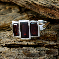Antonia luxurious red trilogy ring with three rectangular red stones set in silver band on rustic wood