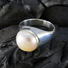 Josephine luxurious white solitaire ring featuring a bezel set pearl on a polished silver band