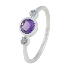 Naomi luxury purple gemstone ring with a round purple center stone and two small clear stones on a silver band