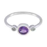 Naomi luxury purple gemstone ring with oval amethyst center and two small clear stones on silver band